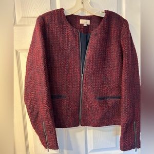 Cropped magenta and navy jacket with zipper details.